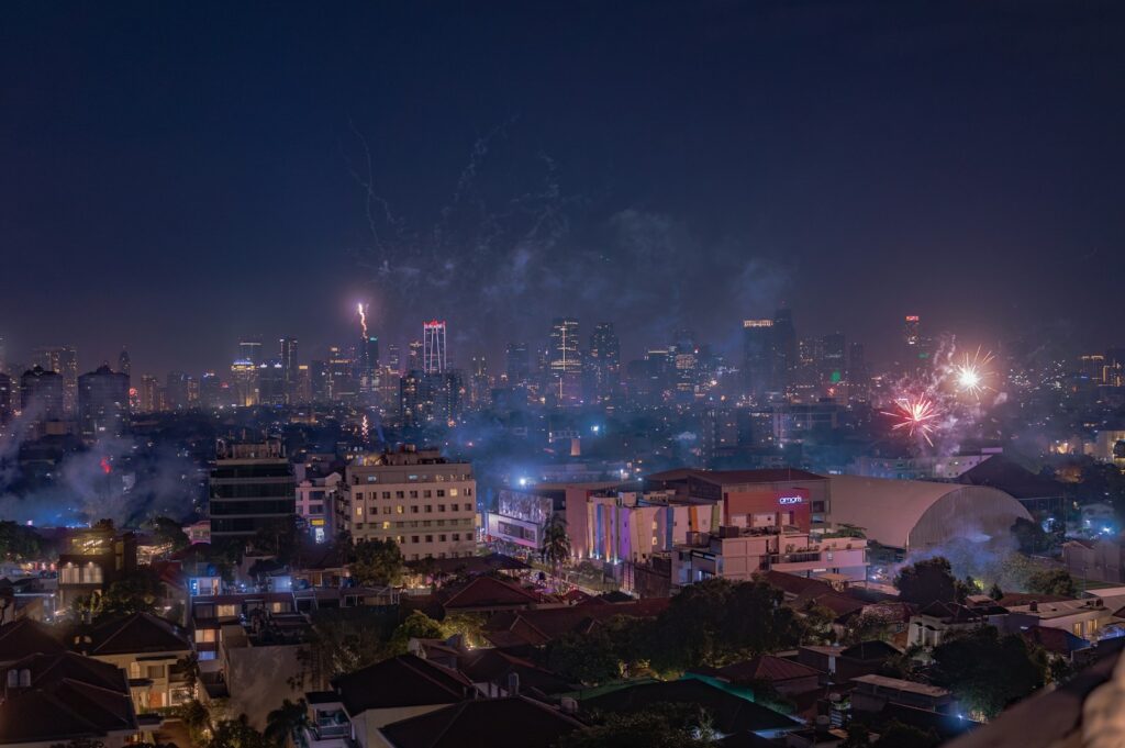 Photo by Alim - Best Travel and Cruise New Zealand A city at night with fireworks in the sky
