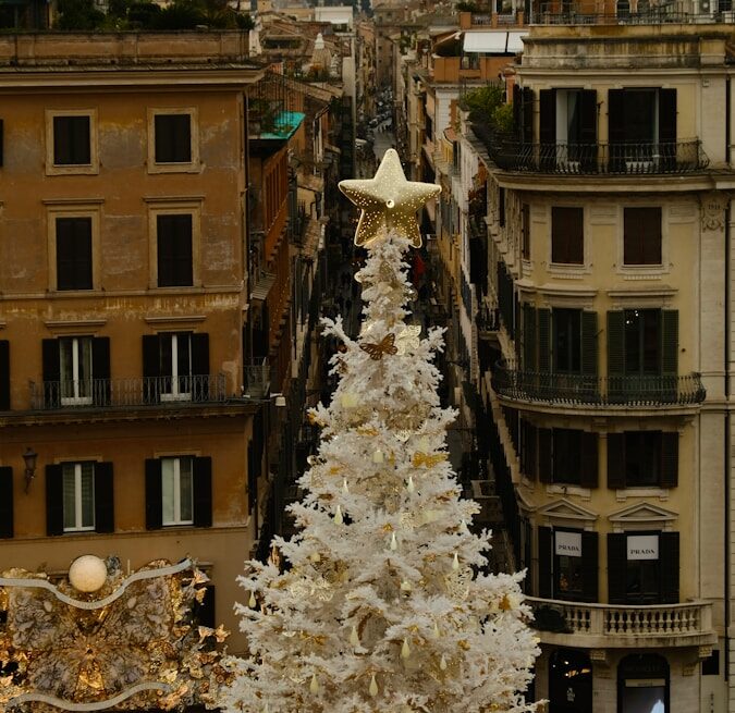 a large white christmas tree in the middle of a city