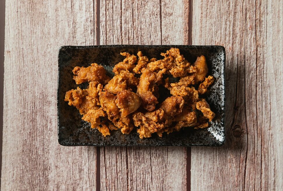 a pile of brown food on a black surface