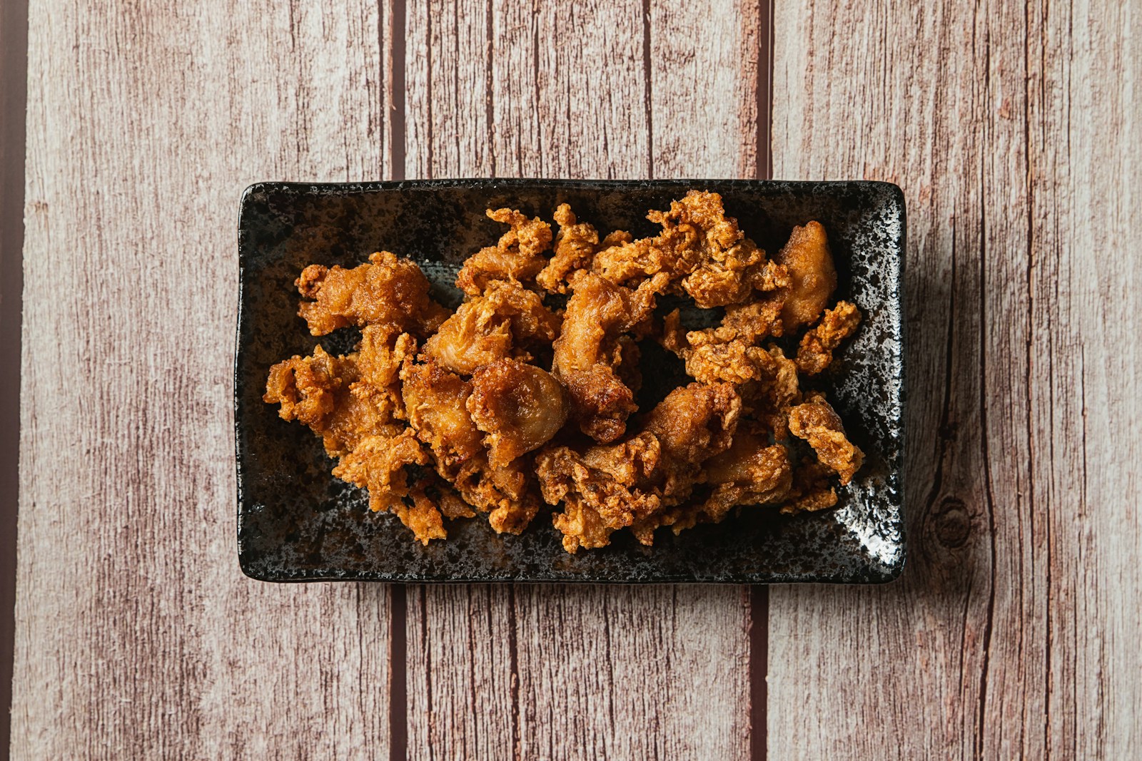 a pile of brown food on a black surface