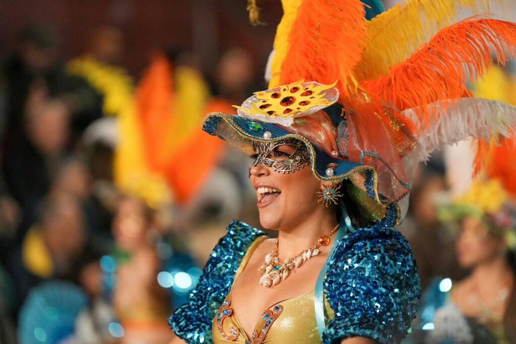 Photo by Markus Kammermann - Best Travel and Cruise New Zealand A woman smiles while wearing a carnival costume.