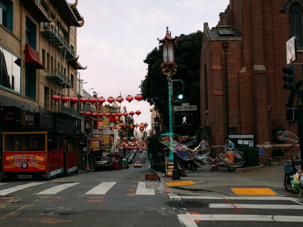 Photo by Kendall Scott - Best Travel and Cruise New Zealand a street with a lot of red lanterns hanging from it's sides