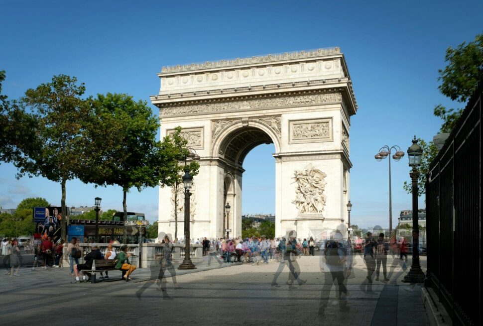a group of people standing in front of a white arch